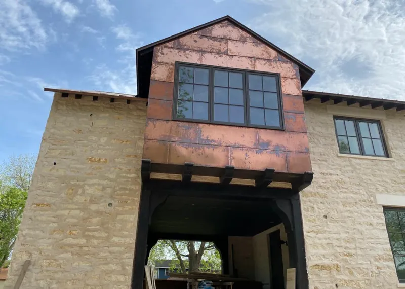 Copper metal panel facade on a stone building for Skylight Installation in Sylvester
