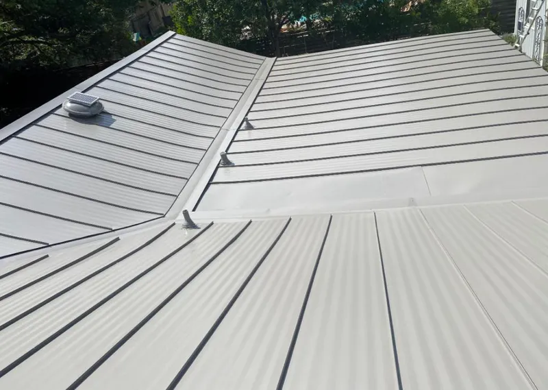 Solar attic fan installed on a metal roof for Roof Ventilation in Sylvester