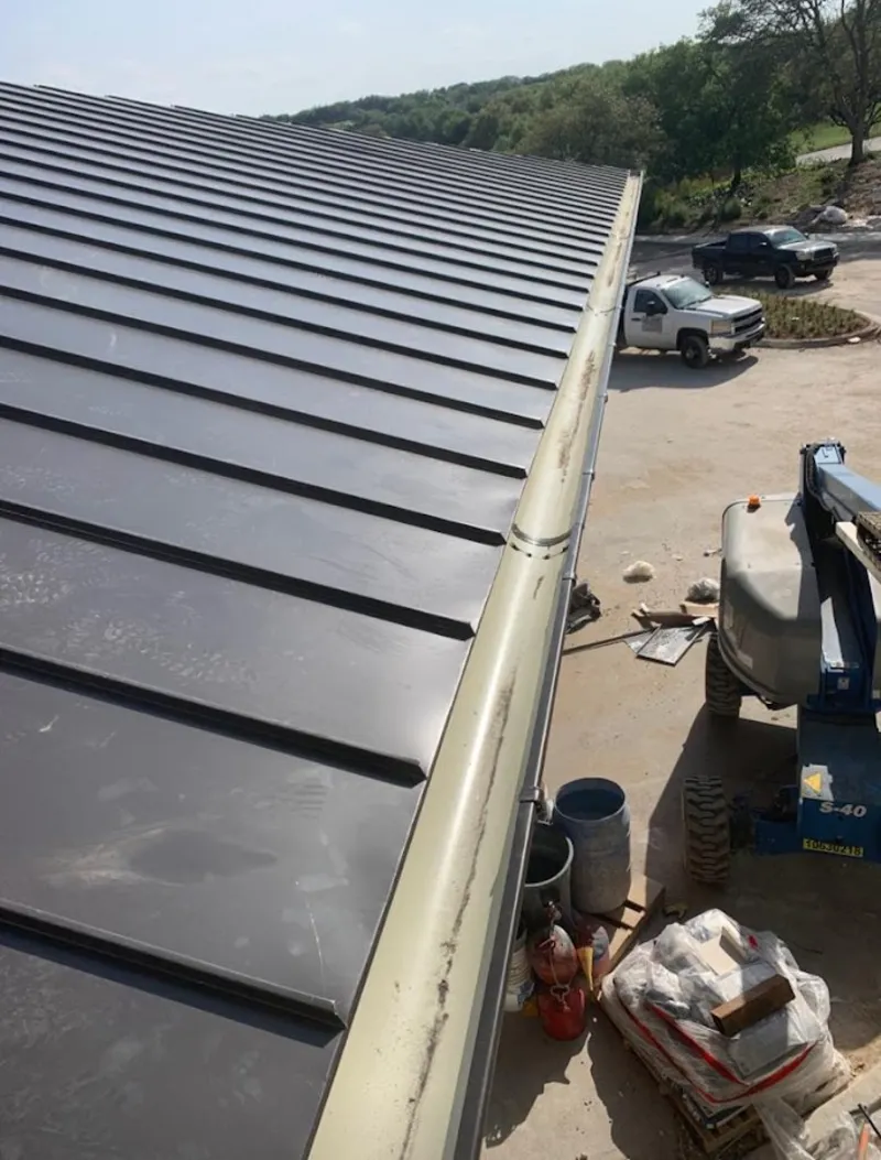 Standing seam panel and gutter detail on a metal roofing jobsite in Sylvester